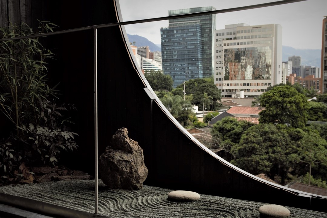 Peaceful Zen garden in Hotel Medellin Nido Sky, designed with stones, sand and carefully arranged plants